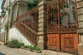 Iron gate covered by rust in front of old mansion Royalty Free Stock Photo