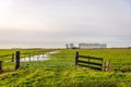 Iron gate in a Dutch polder landscape Royalty Free Stock Photo
