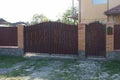 Iron  gate with  forged pattern and brown metal fence Royalty Free Stock Photo