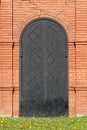 Iron gate in the form of an arch in a brick wall