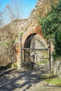 Old Iron gate. Ruined wall