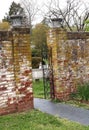 Iron Gate Opens Between Brick Walls at Esate