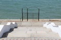 Iron gate by the sea as a symbol of a failed beach season. Overlapping the coastline looks funny and ridiculous