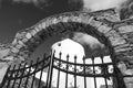 Iron gate and stone arch in Mykonos, Greece. Archway structure or architecture. Whitewashed building on sunny outdoor