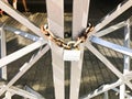 Iron gates, metal bar fence frozen on a strong old rusty chain of links on a granary large lock. The background Royalty Free Stock Photo