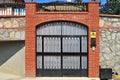 Iron gates and stone wall Royalty Free Stock Photo