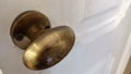 An iron gilded door handle mounted on a white door in a library Royalty Free Stock Photo