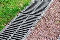 Iron grate of a drainage channel on a landscape.