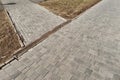 Iron grate of a drainage system for storm water drainage from a pedestrian sidewalk near a lawn