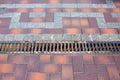 Iron grating line of the drainage system of the pedestrian sidewalk. Royalty Free Stock Photo