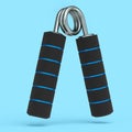 Iron hand expander or resistance band with rubber handle isolated on blue.