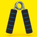 Iron hand expander or resistance band with rubber handle isolated on yellow.