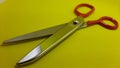 iron handle cloth scissors, cloth cutting scissors, yellow background Royalty Free Stock Photo