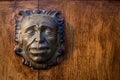 Iron head at the door of a colonial house