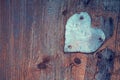 Iron heart, covered with rust on a wooden board