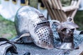 Ancient Iron Knight Helmet and Metal Glove on Desk - Middle Ages Armor Concept Royalty Free Stock Photo