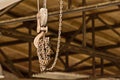 An iron hook on a pulley and a chain Royalty Free Stock Photo