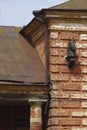 Iron horse head on the brick facade of a abandoned horse factory of the 19th century