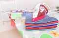 Iron and ironed clothes. Royalty Free Stock Photo