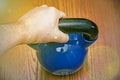 Iron kettlebell in the man`s hand on a wooden background. kettlebells on gym. Close up. Sports kettlebell in the gym, top view. Royalty Free Stock Photo