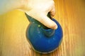 Iron kettlebell in the man`s hand on a wooden background. kettlebells on gym. Close up. Sports kettlebell in the gym, top view. Royalty Free Stock Photo