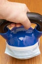 Iron kettlebell in the man`s hand on a wooden background. kettlebells on gym. Close up. Sports kettlebell in the gym, top view Royalty Free Stock Photo