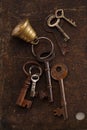 Iron keys with bell on metal backdrop Royalty Free Stock Photo