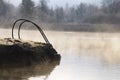 Iron Ladder at the Misty Winter Lake Royalty Free Stock Photo