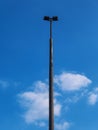 Iron lamp post in front of blue cloudy sky Royalty Free Stock Photo