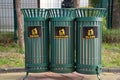 Iron lattice trash bins for sorting garbage - plastic, paper and glass.