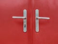 Iron lock with a handle on the red iron door. Royalty Free Stock Photo