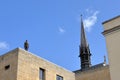 Iron man statue with Exeter College Chapel spike behind it in Oxford, UK Royalty Free Stock Photo