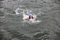 Iron man swimmer in cap and wetsuit breathing performing butterfly stroke