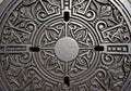 Iron manhole cover featuring intricate patterns and symmetrical Royalty Free Stock Photo