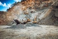 Iron mine, quarry, iron ore mining details. Industrial machinery working with rock breaker and crusher