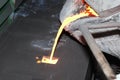 Iron molten metal pouring in sand mold Royalty Free Stock Photo