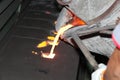 Iron molten metal pouring in sand mold Royalty Free Stock Photo