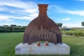 iron monument representing a bottle of Gin Sharish installed in the garden