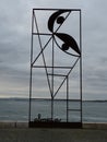 iron monument representing the reminiscence of JosÃÂ© Almada Negreiros in Lisbon with the river Tagus in the background.