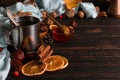 Iron mug with black coffee, honey, spices, on a background of a scarf, dry leaves on a wooden table. Autumn mood, a warming drink Royalty Free Stock Photo