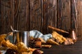 Iron mug with black coffee, spices, dry oranges, on a background of a scarf, dry leaves on a wooden table. Autumn mood, a warming Royalty Free Stock Photo