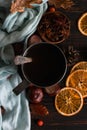 Iron mug with black coffee, spices, dry oranges, on a background of a scarf, dry leaves on a wooden table. Autumn mood, a warming Royalty Free Stock Photo