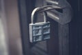 Iron padlock hanging on wooden door in gray tone Royalty Free Stock Photo