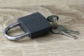 iron padlock with keys in the keyhole on a wooden surface concept prohibition security restriction Royalty Free Stock Photo