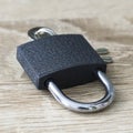 iron padlock with keys in the keyhole on a wooden surface concept prohibition security restriction Royalty Free Stock Photo