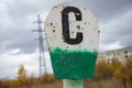 Iron pillar. White-green signpost made of iron