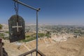 Iron plate with cross and panorama of the Valley of Jericho from Greek orthodox monastery of St. George on the Mount of Temptation Royalty Free Stock Photo