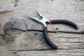 Iron pliers on a old rustic wooden table Royalty Free Stock Photo