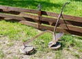 Iron plow at the wooden fence