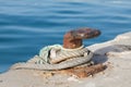 Iron pole for mooring of ships at pier, old rusty iron bollard on a pier on the coast of Andalucia, Spain Royalty Free Stock Photo